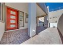Inviting entryway with brickwork and a bright red front door at 991 Golden Summit Ave, Las Vegas, NV 89138