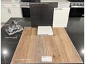 Kitchen sample showcasing stainless steel appliances, Benton Flagstone cabinets, and Simply White Quartz countertop at 10004 River Corral St, Las Vegas, NV 89166