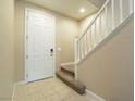 The entryway features tile flooring with a staircase leading to the upper level of the home at 10051 Sand Key St, Las Vegas, NV 89178