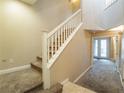 A view of the staircase with carpeted steps and a white railing leading to the upper floor at 10051 Sand Key St, Las Vegas, NV 89178