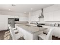 Spacious kitchen showcasing an island with granite countertop, stainless appliances, and white cabinets at 10879 Artesano Ave, Las Vegas, NV 89135