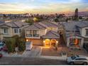 Gorgeous aerial shot of a two-story home with city views at sunset at 1309 Rainy Sky Ave, North Las Vegas, NV 89030