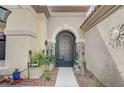 Close up of the elegant entry to the home with beautiful desert landscaping at 2015 Sun Cliffs St, Las Vegas, NV 89134