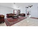 Elegant living room with marble floors, stylish sofas, and a beautiful area rug at 2419 Country Orchard St, North Las Vegas, NV 89030