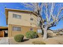 The exterior of a two story apartment building with an old tree at 3821 1/2 Daisy St # 25, Las Vegas, NV 89119