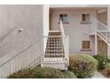Condo stairway with white railings leading to the upper floors, complemented by lush greenery at 4555 E Sahara Ave # 280, Las Vegas, NV 89104