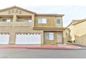 Inviting two-story townhouse featuring attached garage, balcony, and manicured landscaping at 53 Blue Beak Way, Henderson, NV 89012