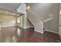 Open floor plan with dark hardwood floors, staircase, and bright, natural light at 53 Blue Beak Way, Henderson, NV 89012