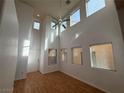 Open floor plan with lots of natural light and laminate floors, showcasing the spacious living room at 5661 Bonds Flat St, Las Vegas, NV 89148