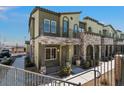 Two-story townhome featuring stone accents, a balcony, and desert landscaping at 6447 Wide Sky St, Las Vegas, NV 89166