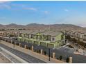 Exterior view of townhomes with garages, sidewalks, and desert landscaping at 6447 Wide Sky St, Las Vegas, NV 89166