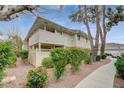 Inviting condo exterior with well-kept landscaping, mature trees, and a partially covered porch at 746 Oakmont Ave # 708, Las Vegas, NV 89109