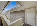 Upstairs entrance showing wood siding with an overhead skylight and covered walkway at 746 Oakmont Ave # 708, Las Vegas, NV 89109