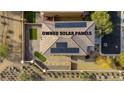 This aerial view showcases the home's roof with owned solar panels, backyard putting green and low maintenance desert landscaping at 7579 Harwich Bay Ave, Las Vegas, NV 89179