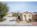 Charming single-story home featuring low-maintenance landscaping and an attached two-car garage at 7726 Coast Jay St, North Las Vegas, NV 89084