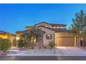 Charming home exterior showcasing a two-car garage and well-maintained landscaping at 79 Rezzonico Dr, Henderson, NV 89011
