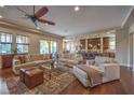 Spacious living room with hardwood floors and open floor plan with view to the kitchen at 79 Rezzonico Dr, Henderson, NV 89011
