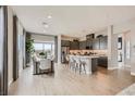 Bright open concept kitchen with a large island, stainless steel appliances, and a dining area at 824 Weston Ridge St, Henderson, NV 89011