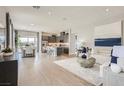 Open-concept living room flows into the modern kitchen with stainless appliances and a dining area with mountain views at 824 Weston Ridge St, Henderson, NV 89011