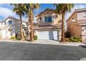 Charming two-story home featuring desert landscaping with mature palm trees and a two-car garage at 832 Clear Diamond Ave, Las Vegas, NV 89123
