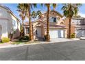 Charming two-story home featuring desert landscaping with mature palm trees and a two-car garage at 832 Clear Diamond Ave, Las Vegas, NV 89123