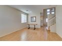 Bright living room with wood floors, staircase, high ceilings, and natural light at 832 Clear Diamond Ave, Las Vegas, NV 89123