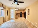 Open-concept dining room adjacent to kitchen with tile flooring and natural light at 8477 Orly Ave, Las Vegas, NV 89143