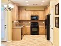 Well-lit kitchen featuring matching appliances, wooden cabinets, and tile flooring at 8477 Orly Ave, Las Vegas, NV 89143