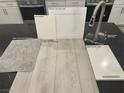 This design sample showcases sleek stainless steel fixtures, white cabinets, and a luxurious warm gray flooring choice at 9141 Eagle Ford St, Las Vegas, NV 89113