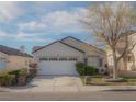 Lovely single-story home featuring a spacious driveway, two-car garage, and beautiful tree at 9323 W Rochelle Ave, Las Vegas, NV 89147