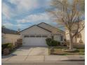 Charming home with a well-maintained lawn, mature tree, and a two-car garage at 9323 W Rochelle Ave, Las Vegas, NV 89147