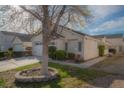 Charming home with mature landscaping, driveway, and a two car garage at 9323 W Rochelle Ave, Las Vegas, NV 89147
