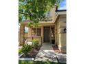 Inviting front entrance with a covered porch, complemented by tasteful landscaping and window details at 11005 Edina Ct, Las Vegas, NV 89144