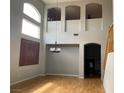 Spacious living area with archways, wood floors, tall windows, and a hanging light fixture at 11005 Edina Ct, Las Vegas, NV 89144