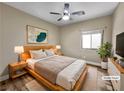 Cozy bedroom features a ceiling fan, natural light, and comfortable decor at 1313 Andrew David Ave, North Las Vegas, NV 89086