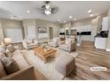 Bright, open-concept living room with modern decor, hardwood floors, and access to the kitchen at 1313 Andrew David Ave, North Las Vegas, NV 89086