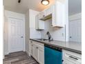 Bright kitchen featuring white cabinets, gray countertops, and a stainless steel sink at 2200 S Fort Apache Rd # 2023, Las Vegas, NV 89117