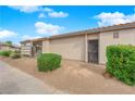 Single-story home featuring a stucco exterior, desert landscaping, and a tiled roof on a sunny day at 255 N Lamb Blvd # F, Las Vegas, NV 89110