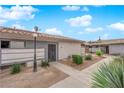 Single-story homes with stucco exteriors, desert landscaping, tile roofs, and inviting walkways at 255 N Lamb Blvd # F, Las Vegas, NV 89110