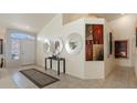 Bright entry foyer with neutral tones, tile flooring, high ceilings, and artistic decor at 2766 Chokecherry Ave, Henderson, NV 89074