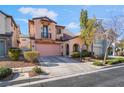 Charming two-story home with a balcony, arched entryway, and easy-care landscaping at 2851 Glistening Grove Ave, Henderson, NV 89052