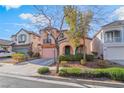 A lovely two-story home boasting a balcony, archway and well-maintained landscaping at 2851 Glistening Grove Ave, Henderson, NV 89052