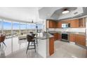 Modern kitchen featuring granite countertops, stainless steel appliances, and a breakfast bar with city views at 322 Karen Ave # 1507, Las Vegas, NV 89109