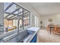 Kitchen sink with modern faucet and a view to the outdoor patio with dining at 3365 Zephyr Ct, Las Vegas, NV 89121