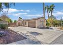 Exterior view of the home and driveway, showcasing a well-manicured front yard at 337 Glenridding St, Las Vegas, NV 89183