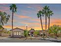 Charming exterior featuring a well-maintained landscape and towering palm trees at sunset at 337 Glenridding St, Las Vegas, NV 89183