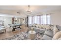 Spacious living room with a large sectional sofa, pool table, and lots of natural light at 3991 Shadow Wood Ave, Las Vegas, NV 89121