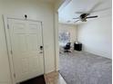Inviting entryway with neutral-toned walls, carpeted floor, and a view leading into the living area at 4780 Lorenzo Way, Pahrump, NV 89061