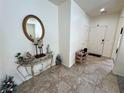 Welcoming foyer with tile flooring, a decorative console table, and a view of the front door at 4780 Lorenzo Way, Pahrump, NV 89061
