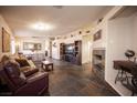 Spacious living room featuring tile flooring and a cozy fireplace at 5014 Sail Rock Pl, North Las Vegas, NV 89031